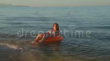 穿着<strong>泳</strong>衣在海上游<strong>泳</strong>的红发女子在游<strong>泳圈</strong>晒太阳。